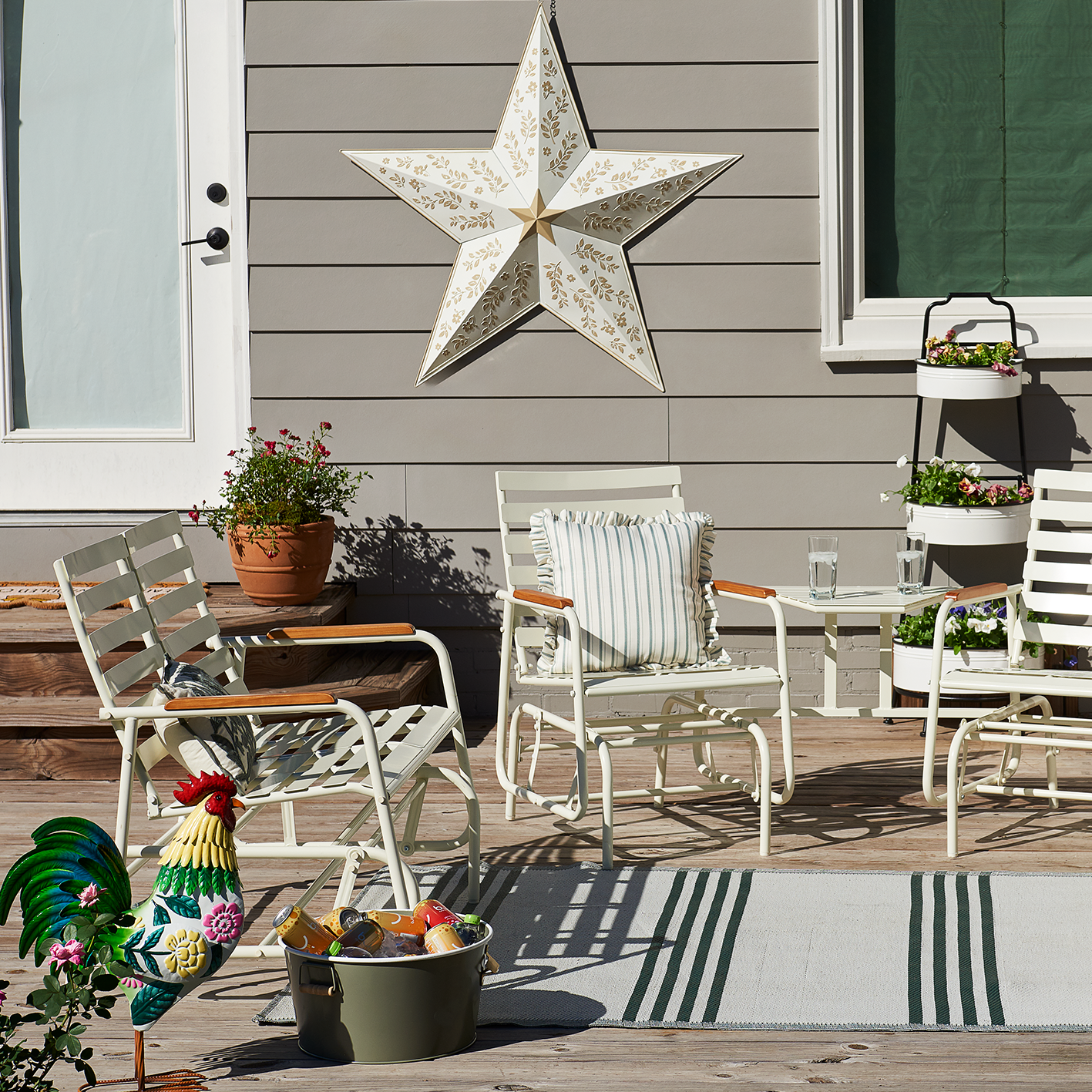 Red Shed Farmhouse patio set with metal chairs, table and star wall decor. See items.