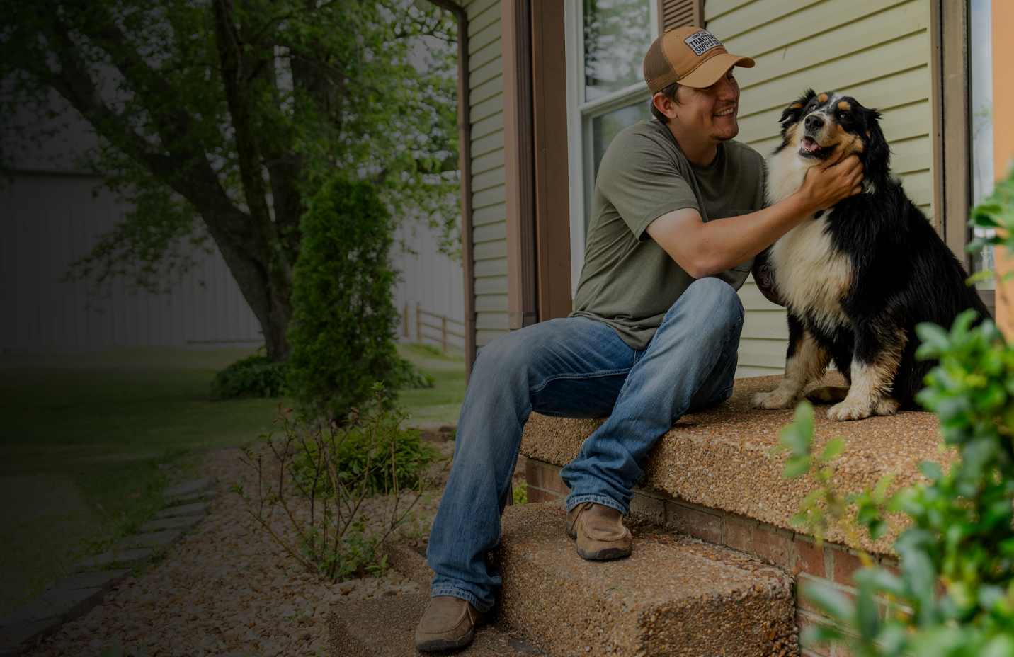 A man petting a happy dog on a porch. New year, new ways to boost their well-being. Shop pet supplements and vitamins.