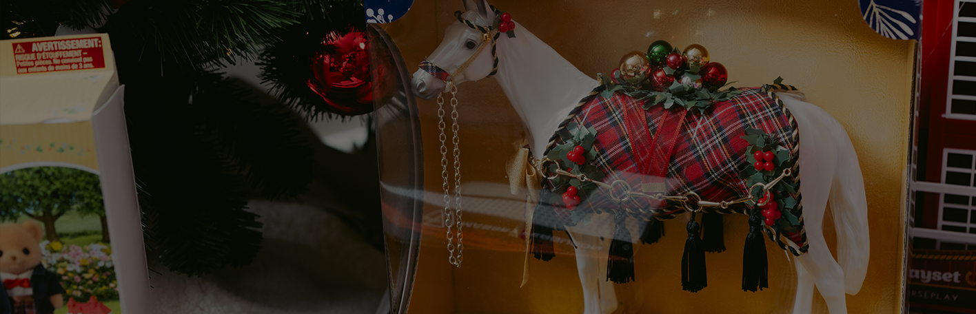 A Breyer horse and accessories are shown. Banner reads, exclusive and limited-edition toys. Wish-list favorites from Breyer. Shop now.