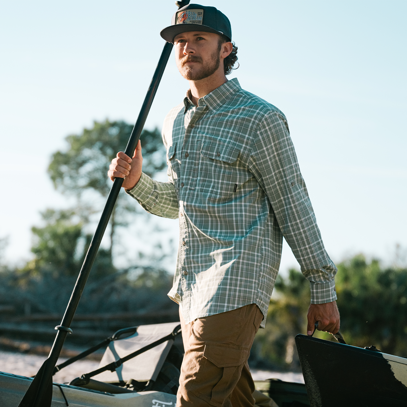 Shop the look for Field and Stream at Tractor Supply, eaturing man carrying fishing gear.