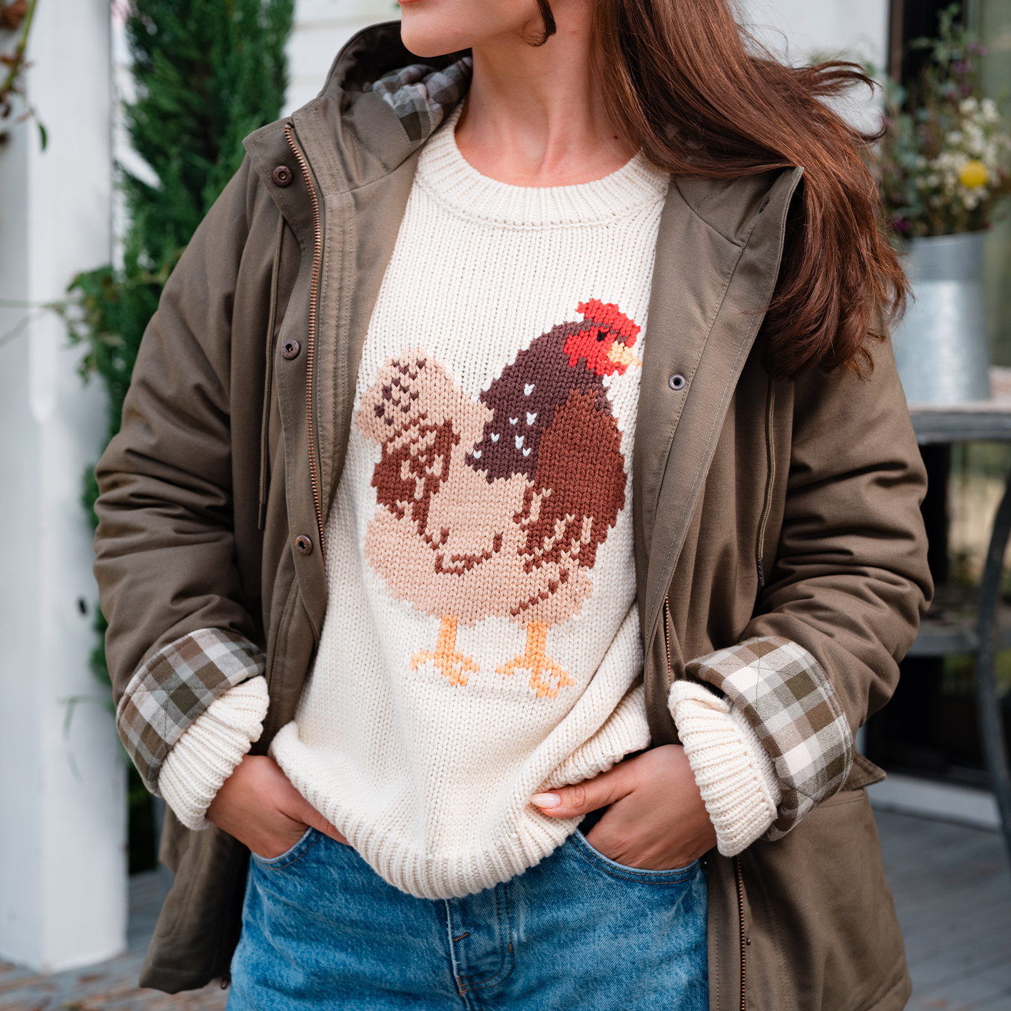 A woman wearing a rooster graphic tee and jacket is shown. See items.