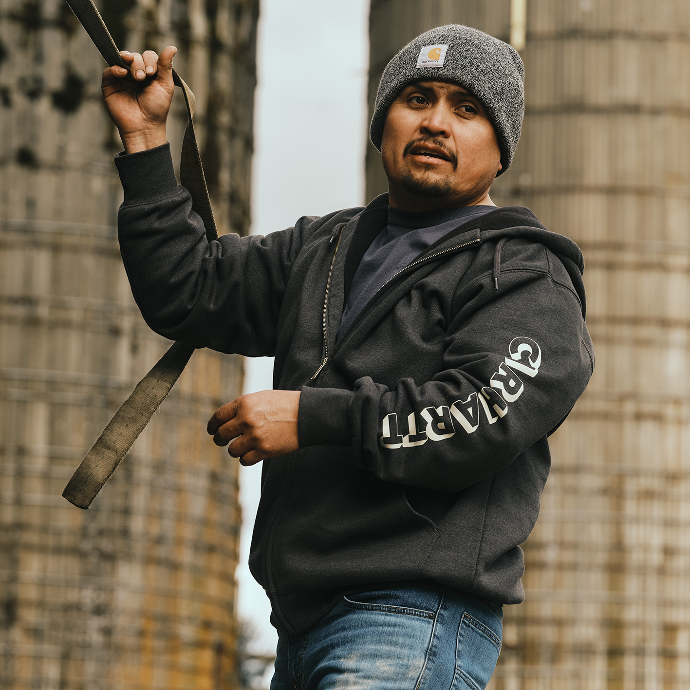 Man wearing a Carhartt beanie cap and sweatshirt