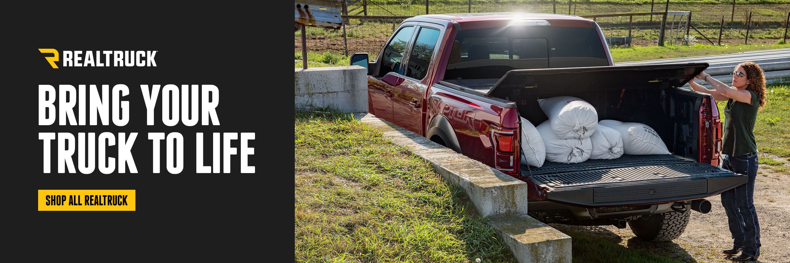 A woman closing a hard tonneau on a truck bed. Realtruck. Bring your truck to life. Shop now. 