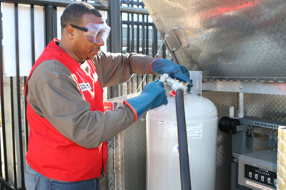 Tractor supply store associate filling propane tank