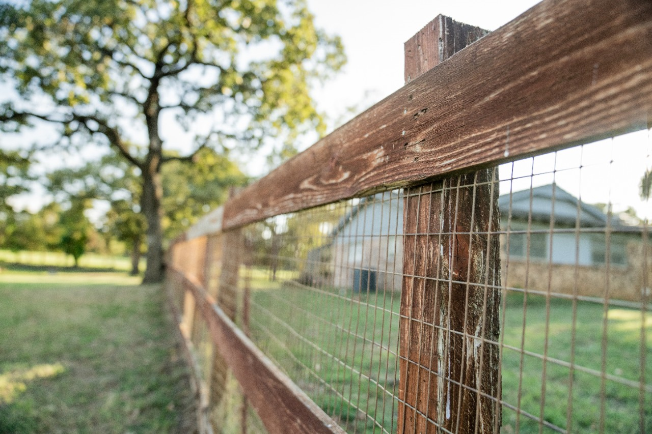 Image of a wooden fence with metal wire.
