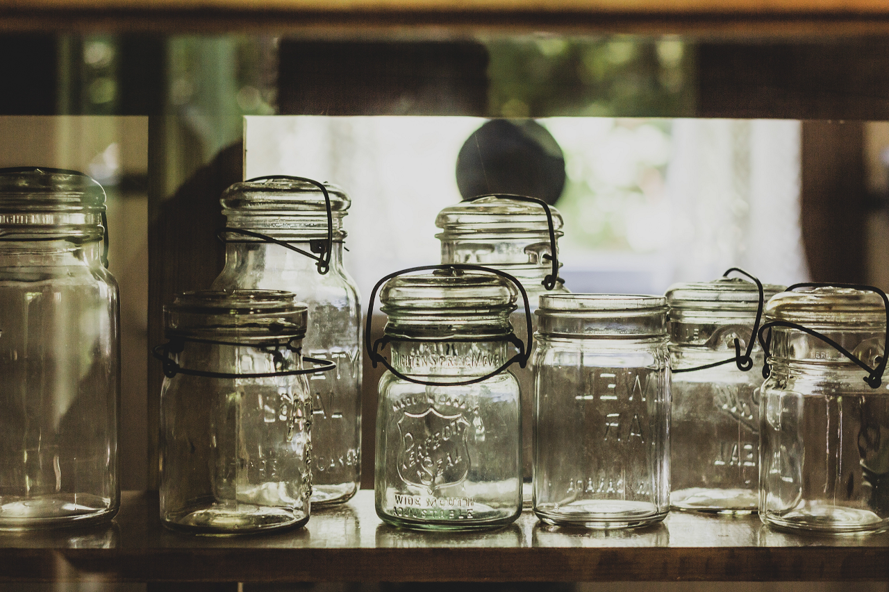 Image of canning jars on a shelf.