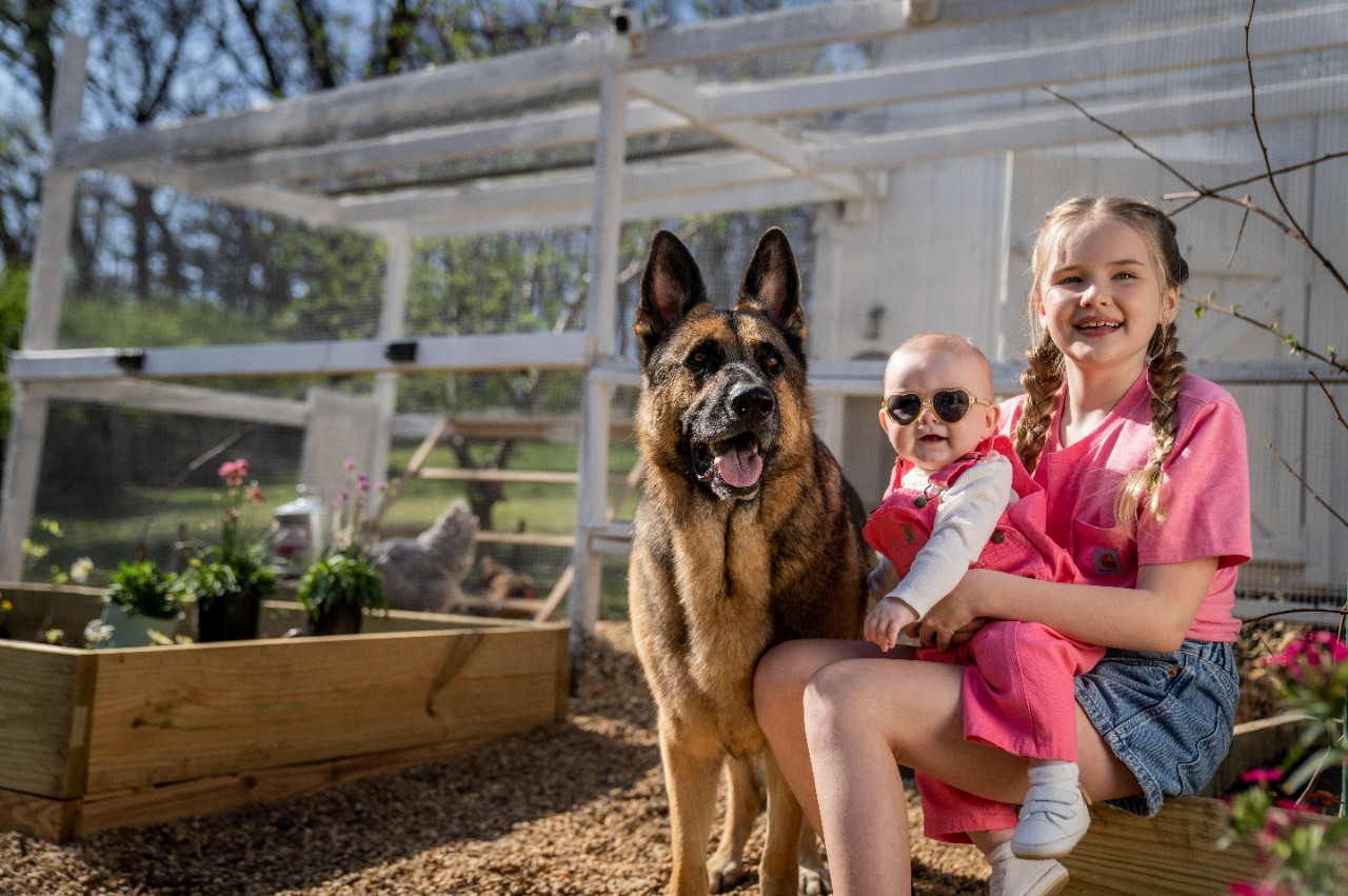 Image of two kids with a dog.
