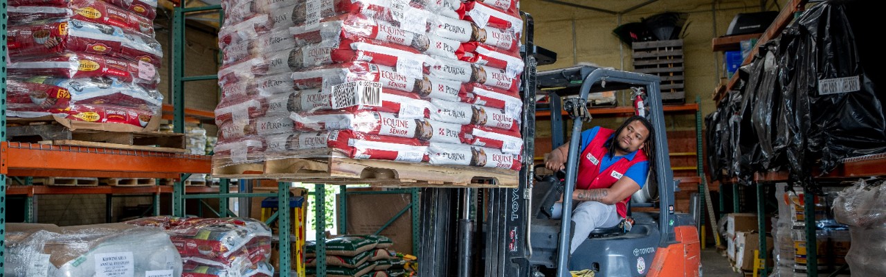 Tractor supply Store associate moving pallets